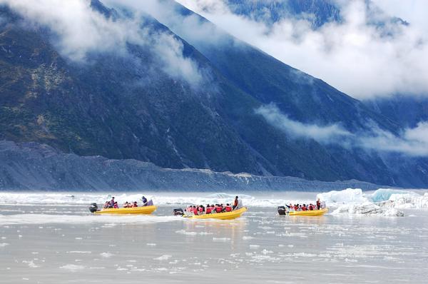 Three Glacier Explorer boats head towards the icebergs